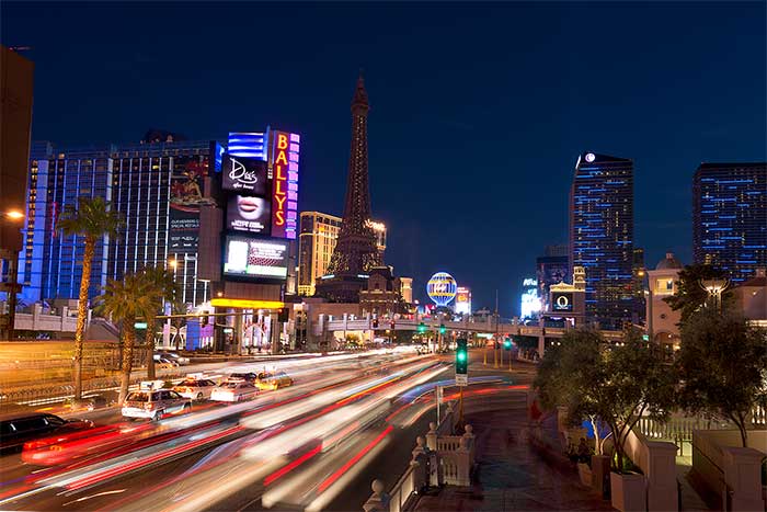 Las Vegas freeway at night with strip background.